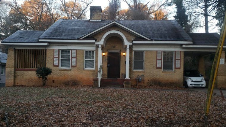 A 1920s yellow-brick home with an arched front entry