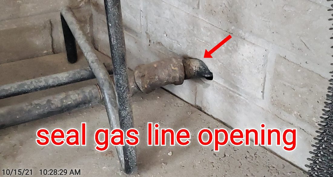 An unsealed opening around the gas line where it enters the firebox